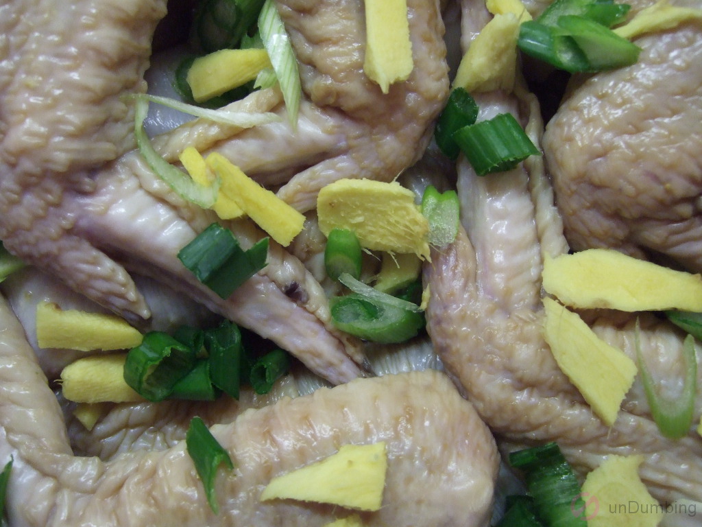 Raw chicken with green onions and ginger