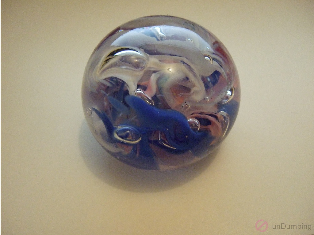 Paperweight with glare on warm white background