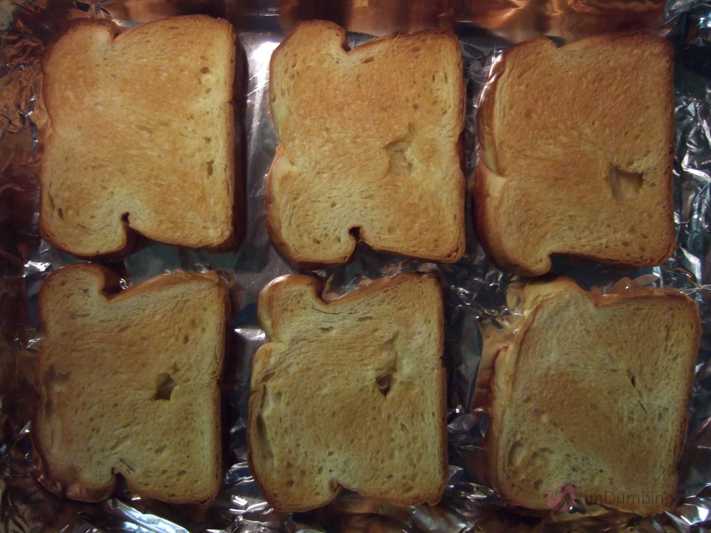 Six toasted slices of brioche in a baking pan