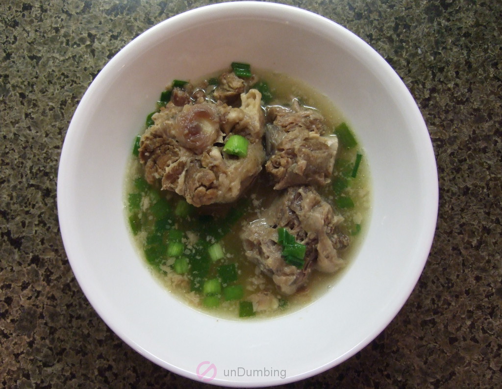 Oxtail soup in a bowl with green onions