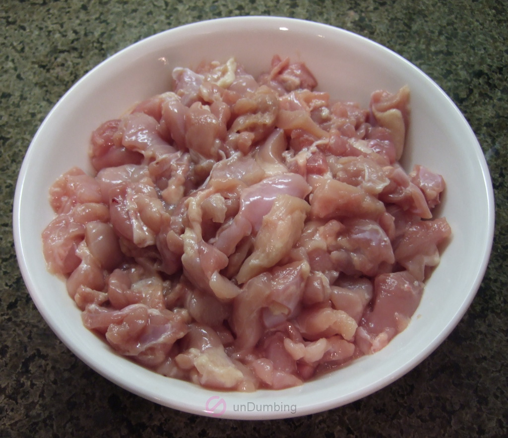 Bowl of chicken thighs cut up