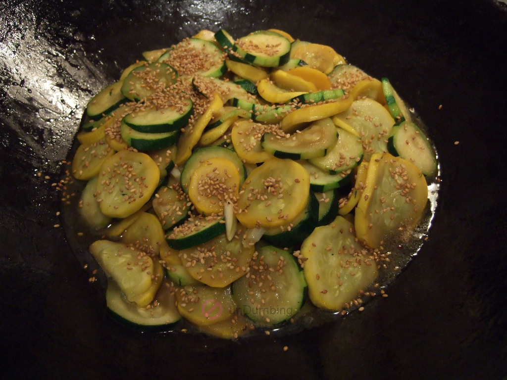 Cooked squash with sesame seeds in a wok