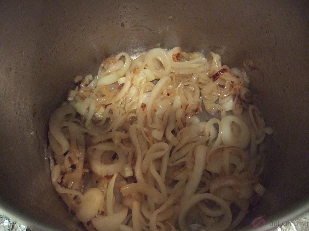 Golden cooked onions in a pot