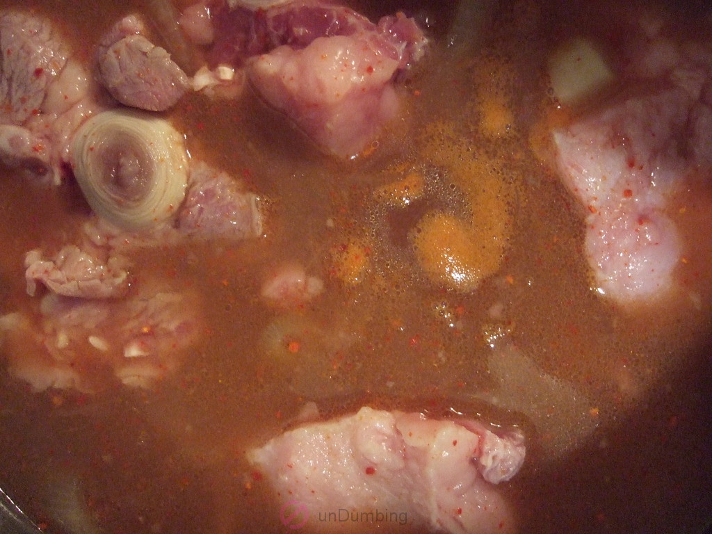 Oxtail and other ingredients braising in a pot