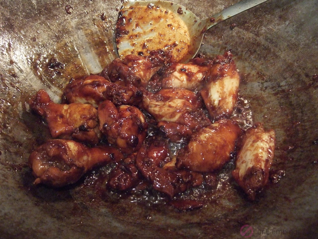 Wok of chicken wings with dried up sauce