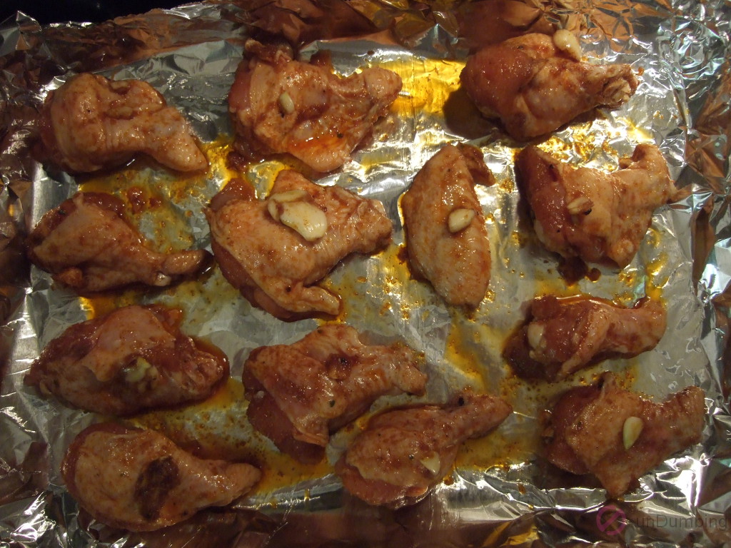 Marinated chicken wings on a baking sheet