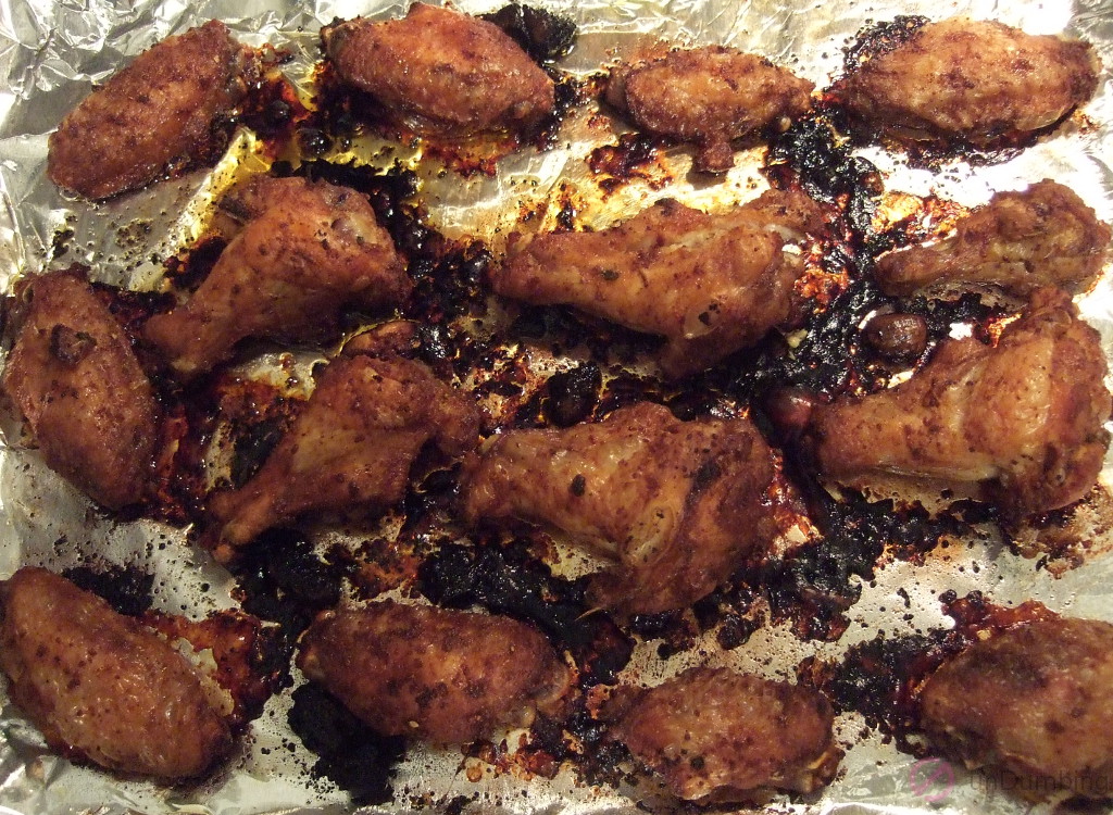 Cooked chicken wings on a baking sheet