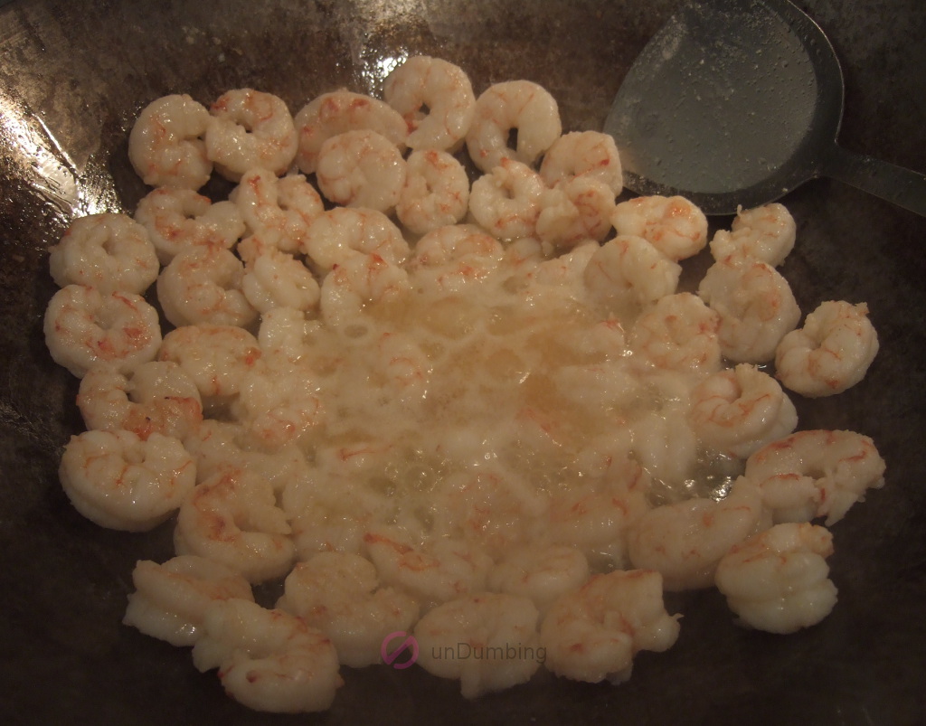 Cooking shrimp in a wok