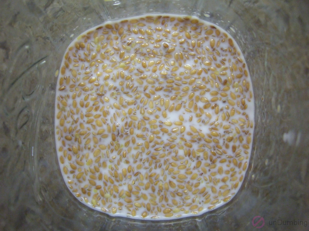 Jar of milk, flaxseed, honey, vanilla extract, and salt