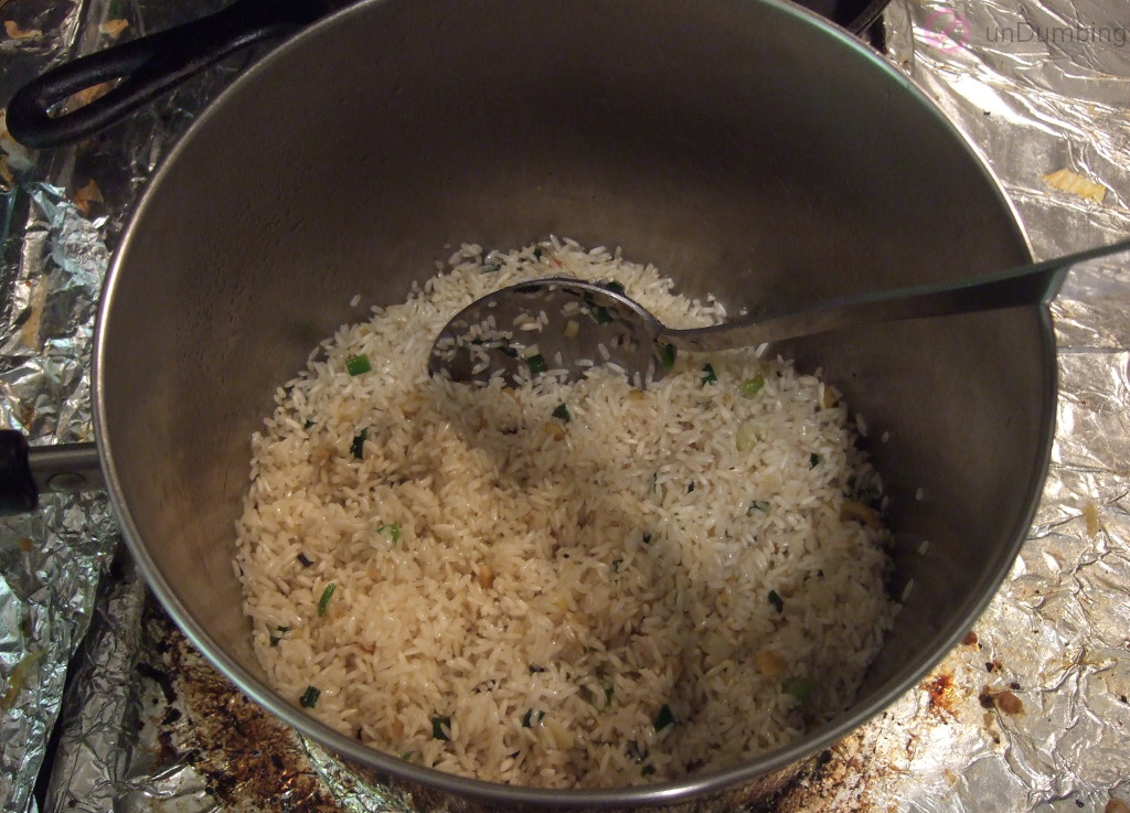 Ginger, green onions, garlic, and rice in saucepan