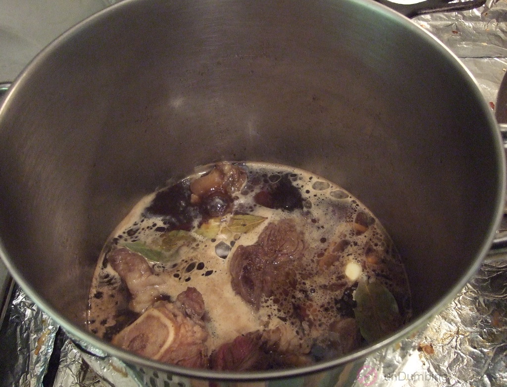 Pot of simmering beef shanks