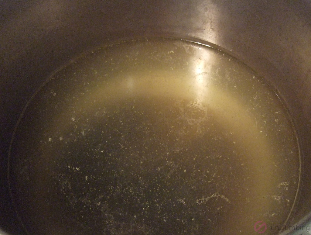 Strained broth in saucepan