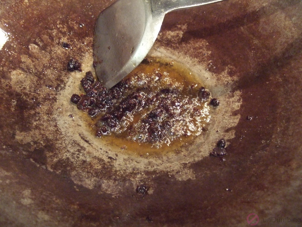 Sautéing black bean garlic sauce in a wok