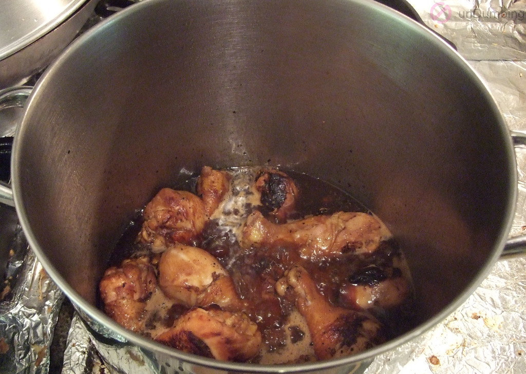 Simmering pot of chicken with bay leaves and peppercorns