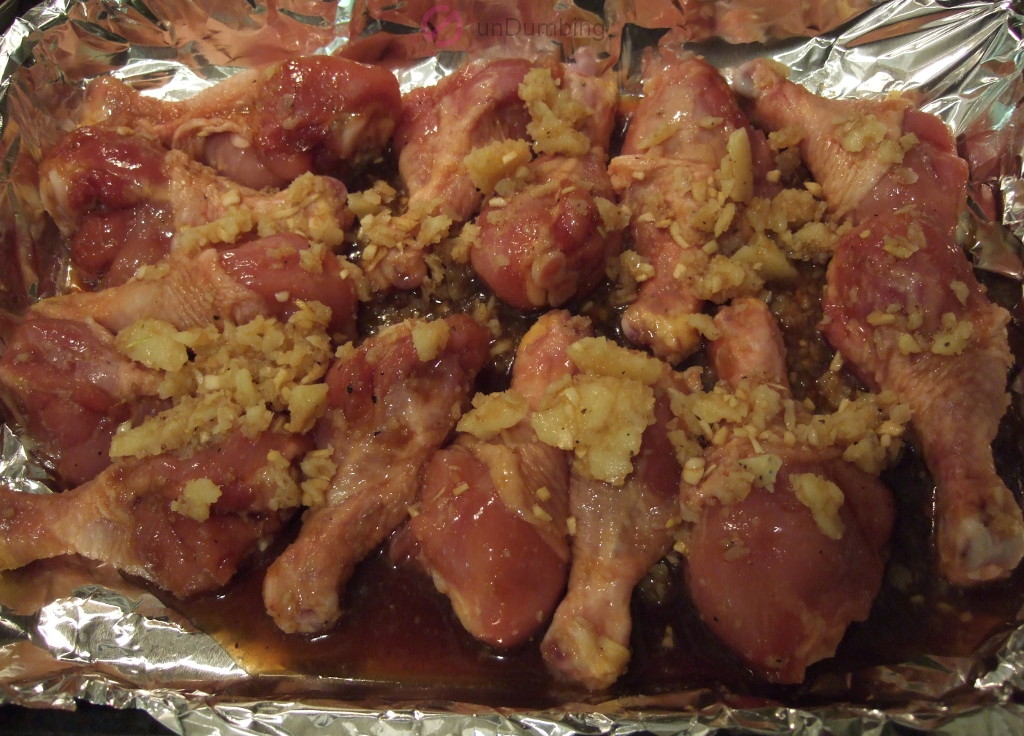 Chicken with marinade in a baking pan