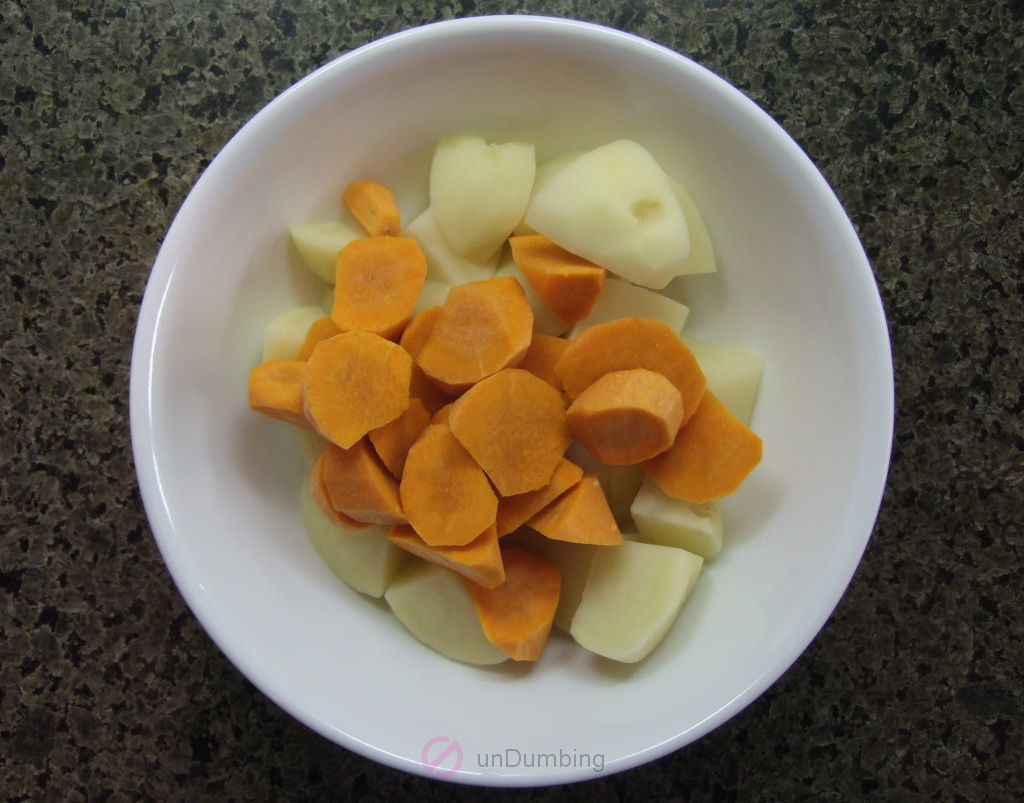 Peeled and cut potatoes and carrots in a bowl