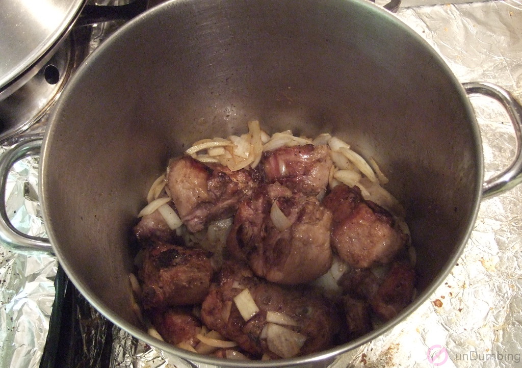 Oxtail sautéed with onion and garlic in a pot