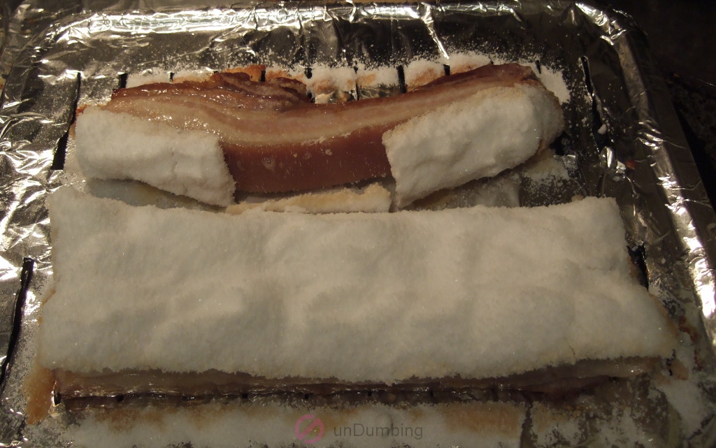 Baked pork belly with salt crust on a slotted pan