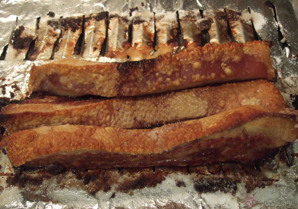 Pork belly with bubbly, crispy skin on a slotted pan
