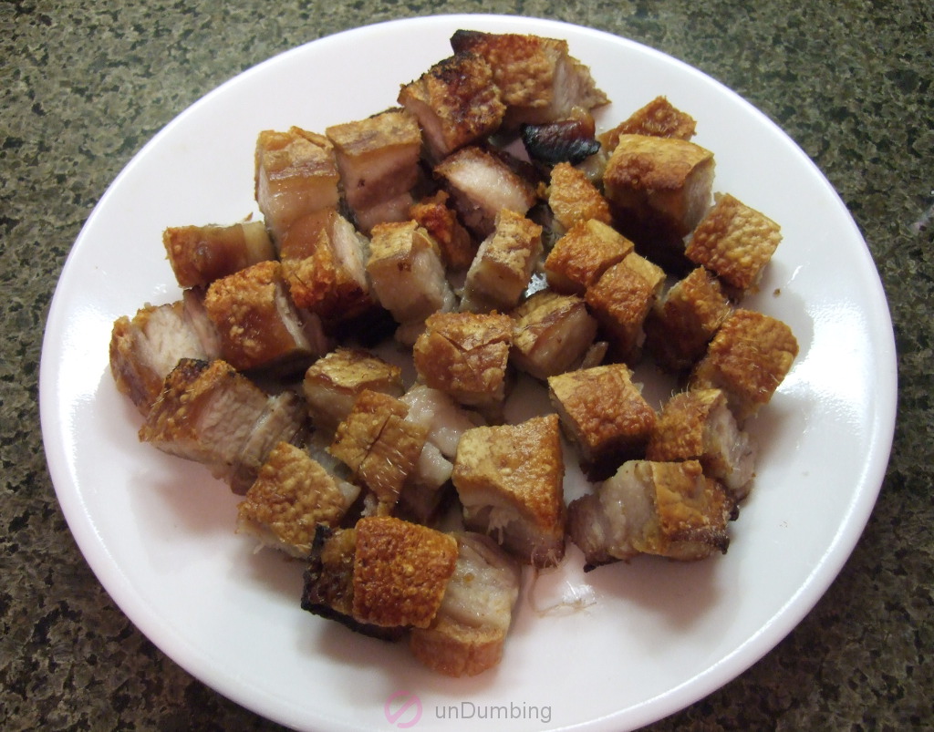 Cut pork belly on a round, white plate