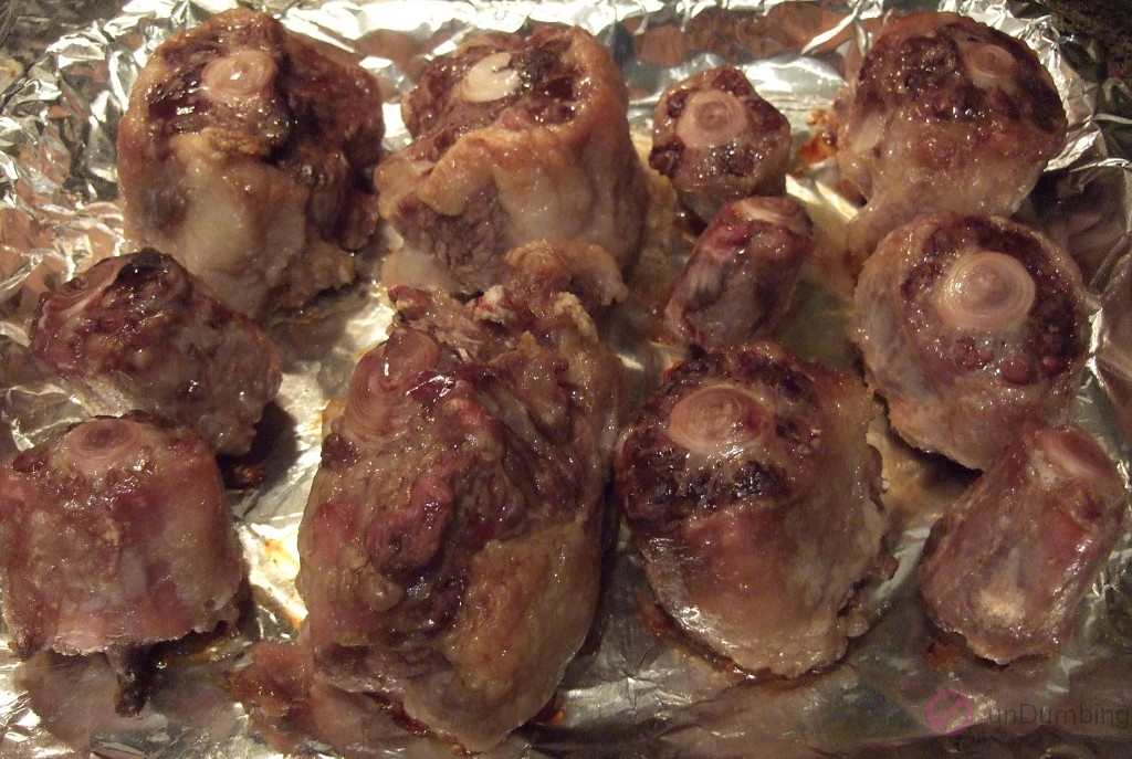 Roasted oxtail on foil-lined baking sheet