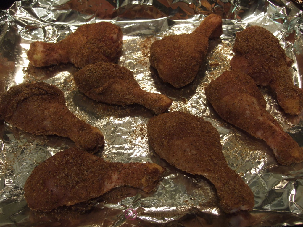 Drumsticks on foil-lined baking tray before cooking