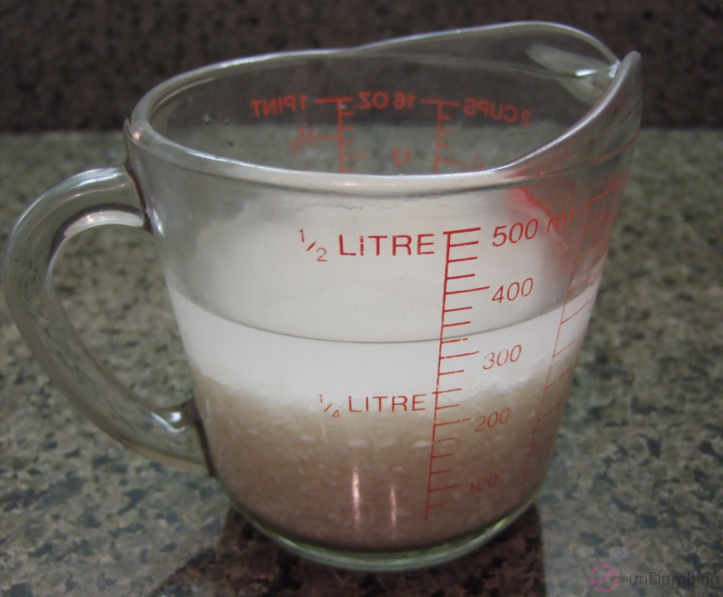 Rice soaking in a measuring cup