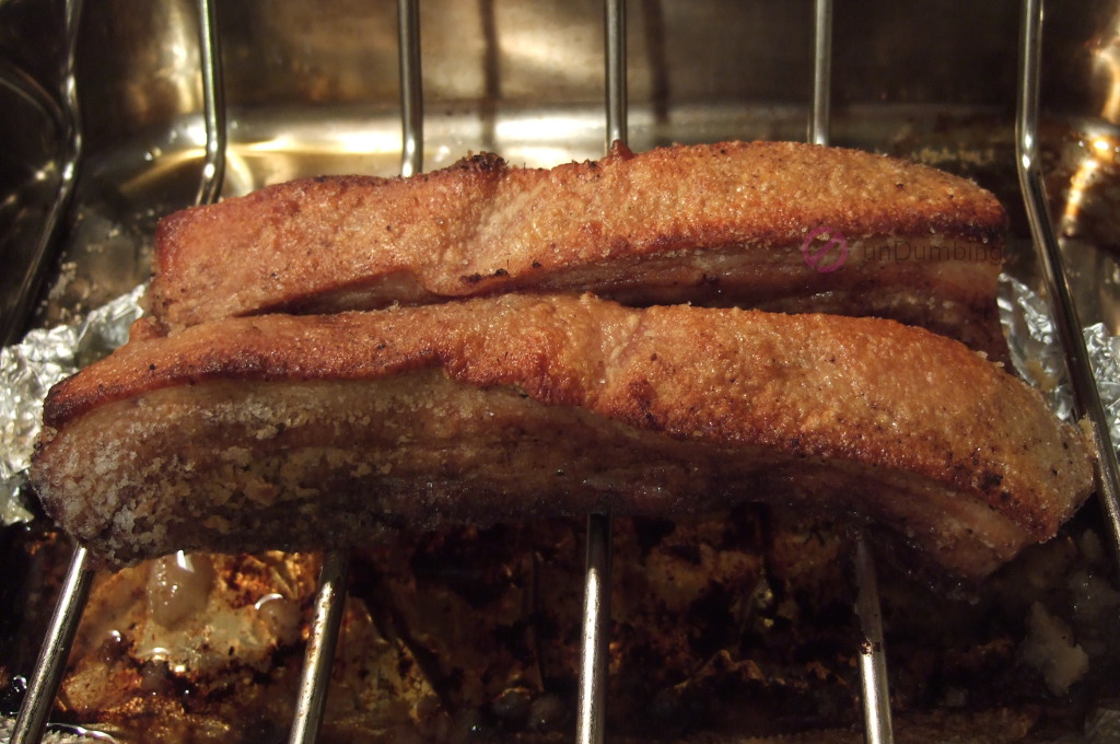 Roasted pork belly on a roasting rack/pan with crispy skin