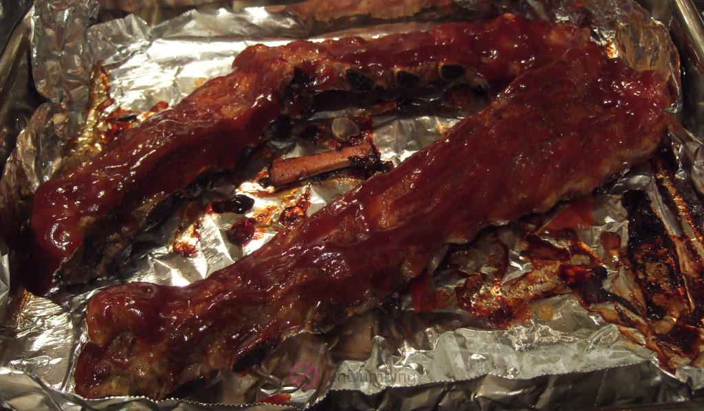 Sauce on the ribs in a roasting pan before baking