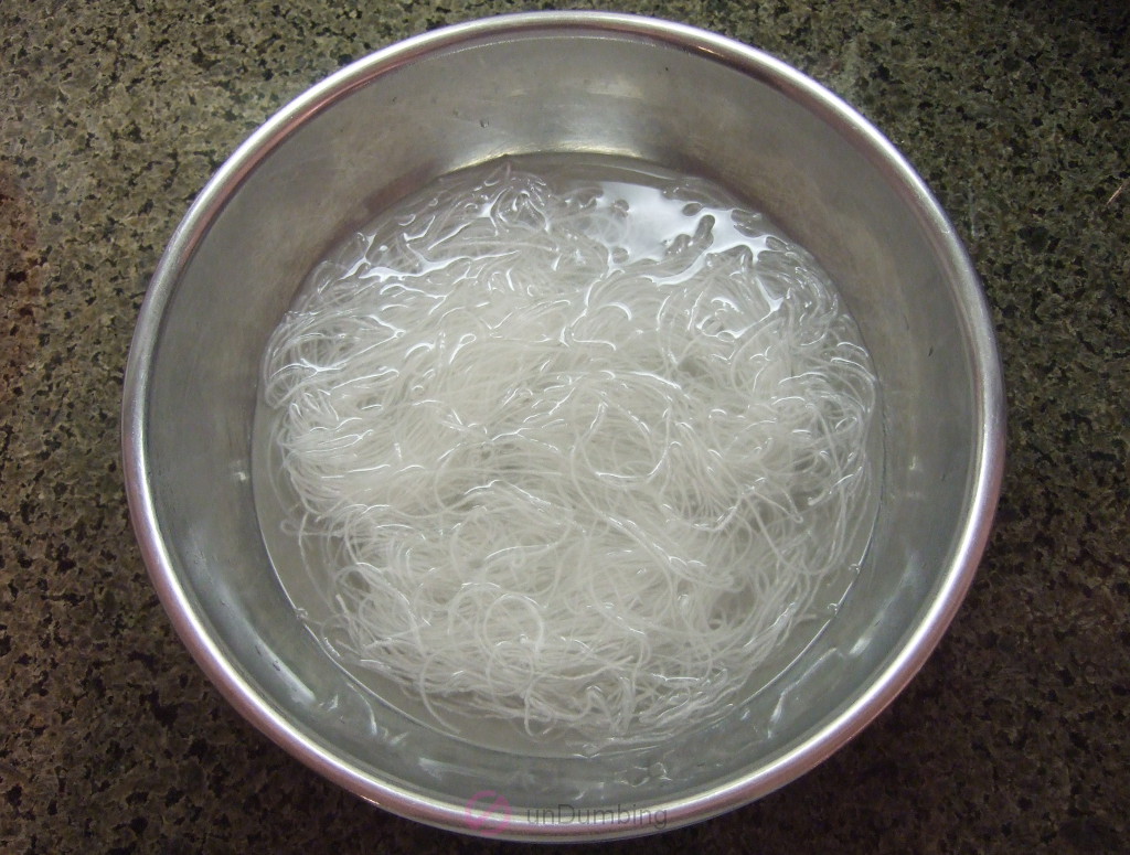 Bean thread noodles soaking in a metal bowl