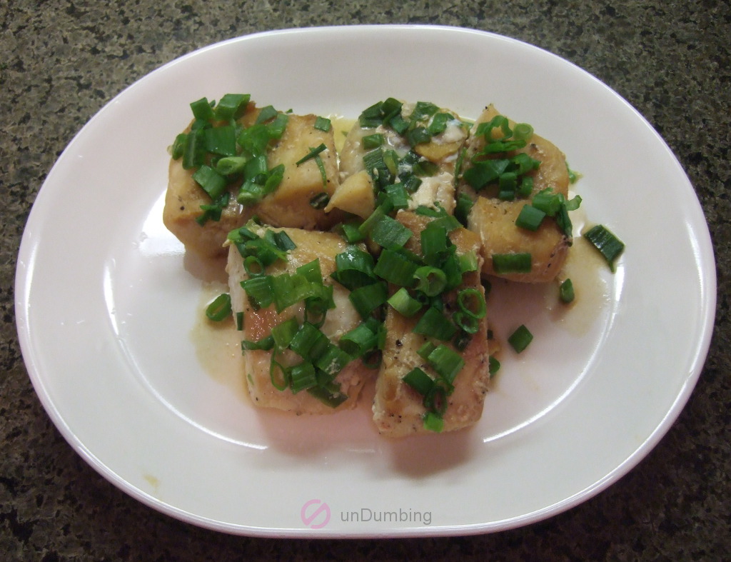 Steamed cod on white plate