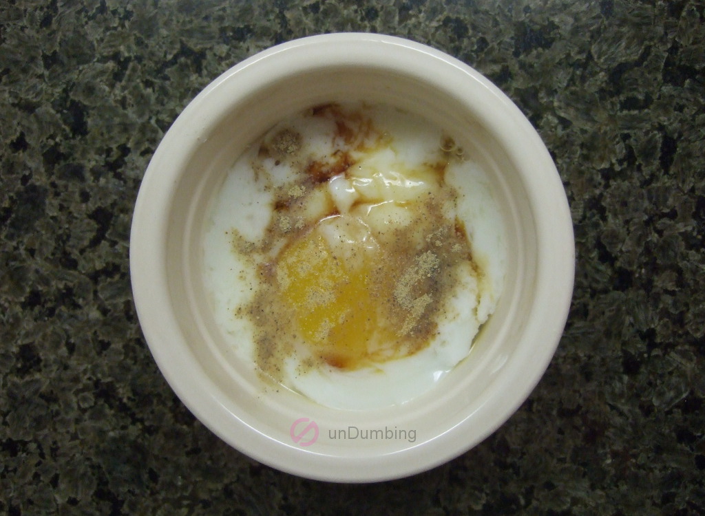 Poached egg in an off-white ramekin with soy sauce and white pepper (Try 2)