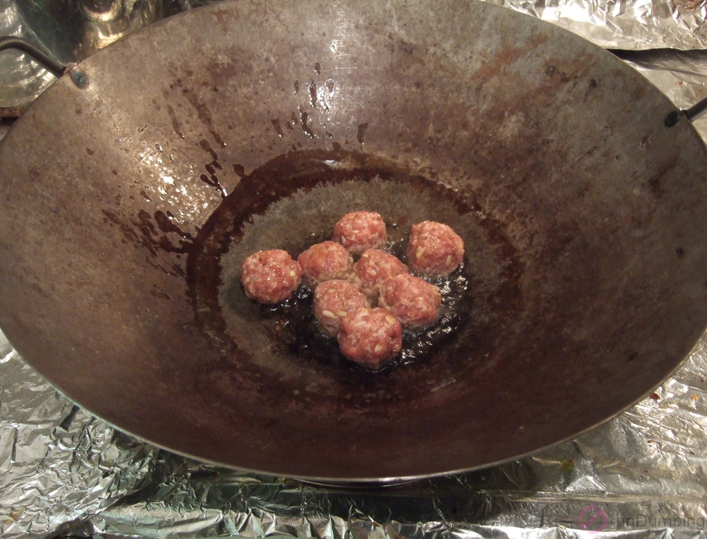 Meatballs cooking in a wok