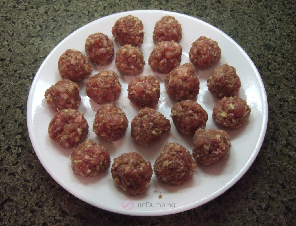 White plate of raw meatballs
