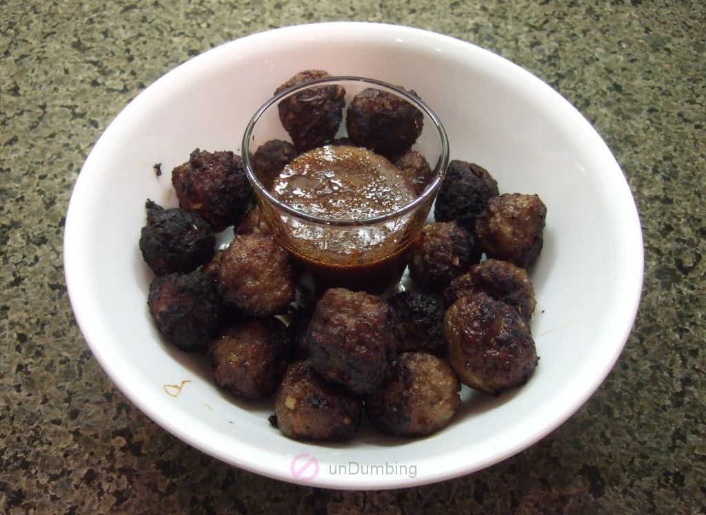 Meatballs with dipping sauce in a white bowl
