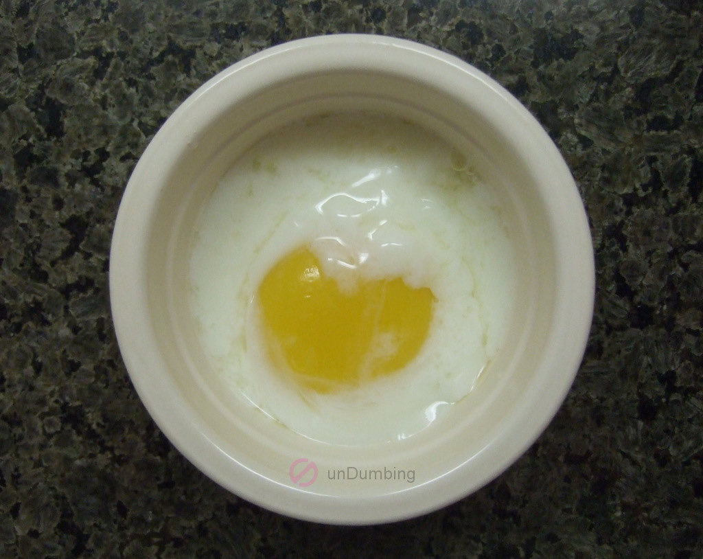 Poached egg in an off-white ramekin before seasoning