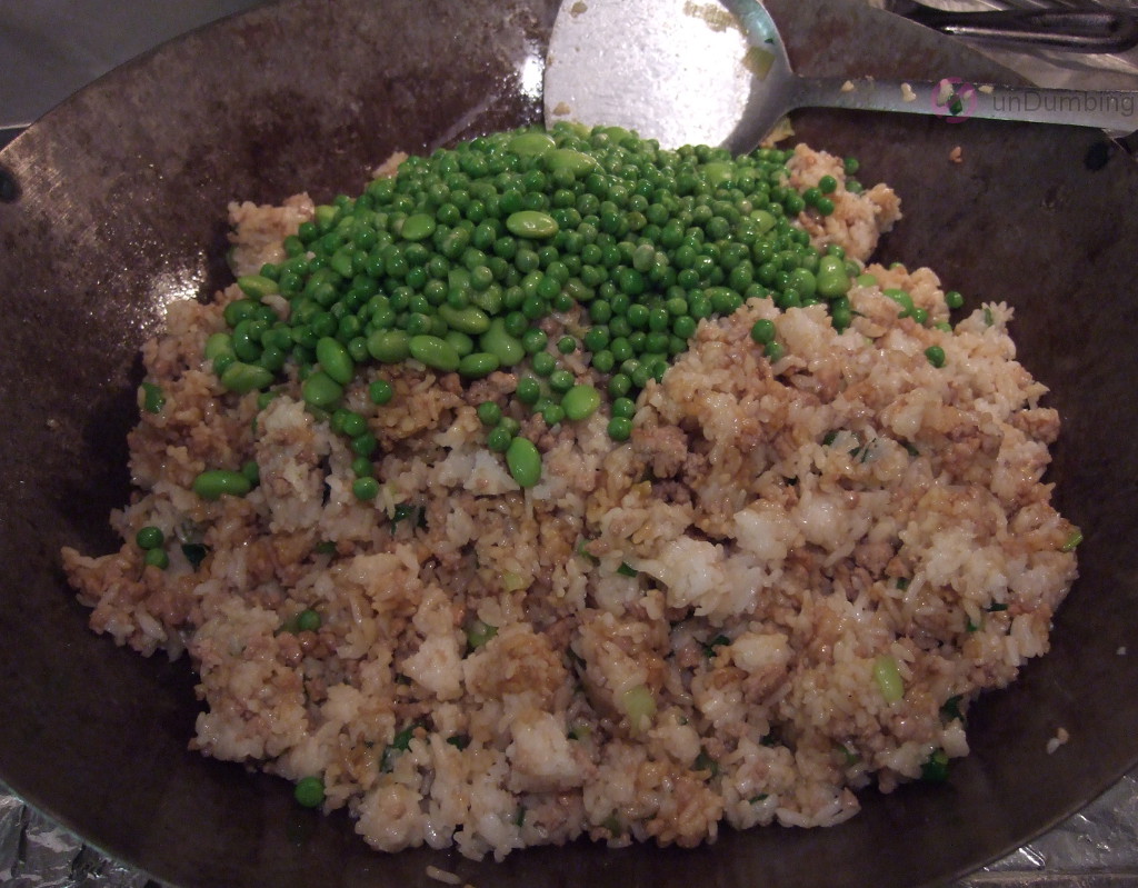 Frozen vegetables added to the rice in the wok