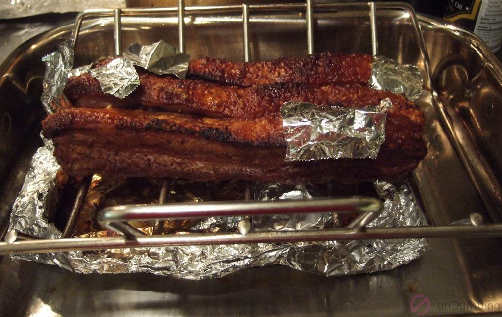 Crispy pork belly with foil patches on a roasting rack/plan