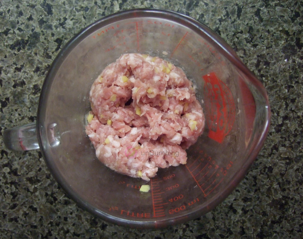 Marinated pork in glass measuring cup