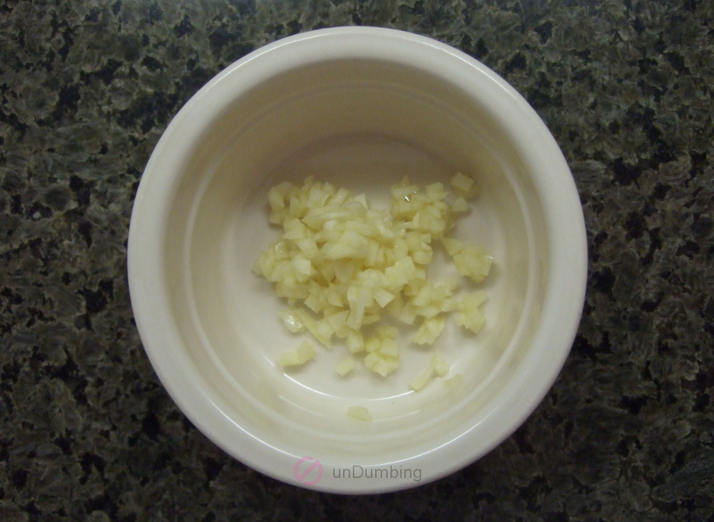 Minced garlic cloves in an off-white ramekin