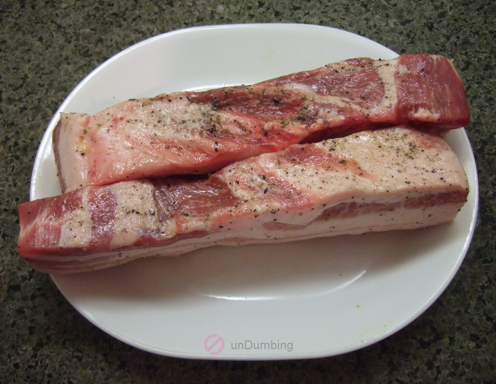 Seasoned pork belly flesh on a white plate