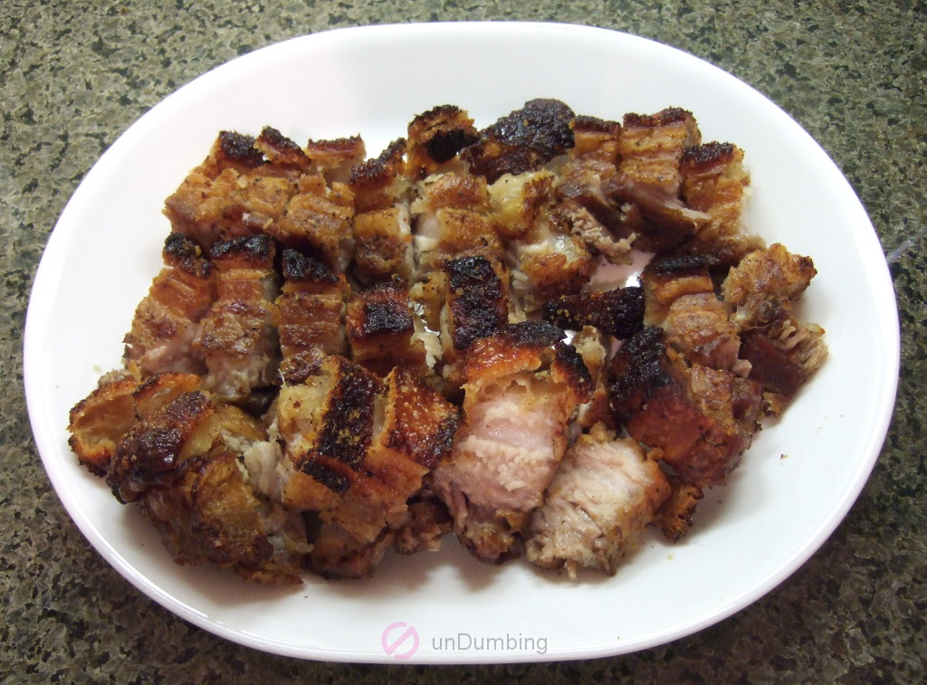 Sliced pork belly on a white plate