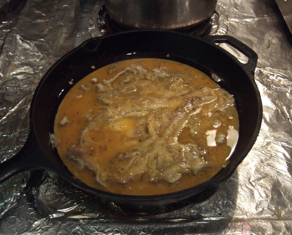 Egg and eggplant mixture cooking in a skillet