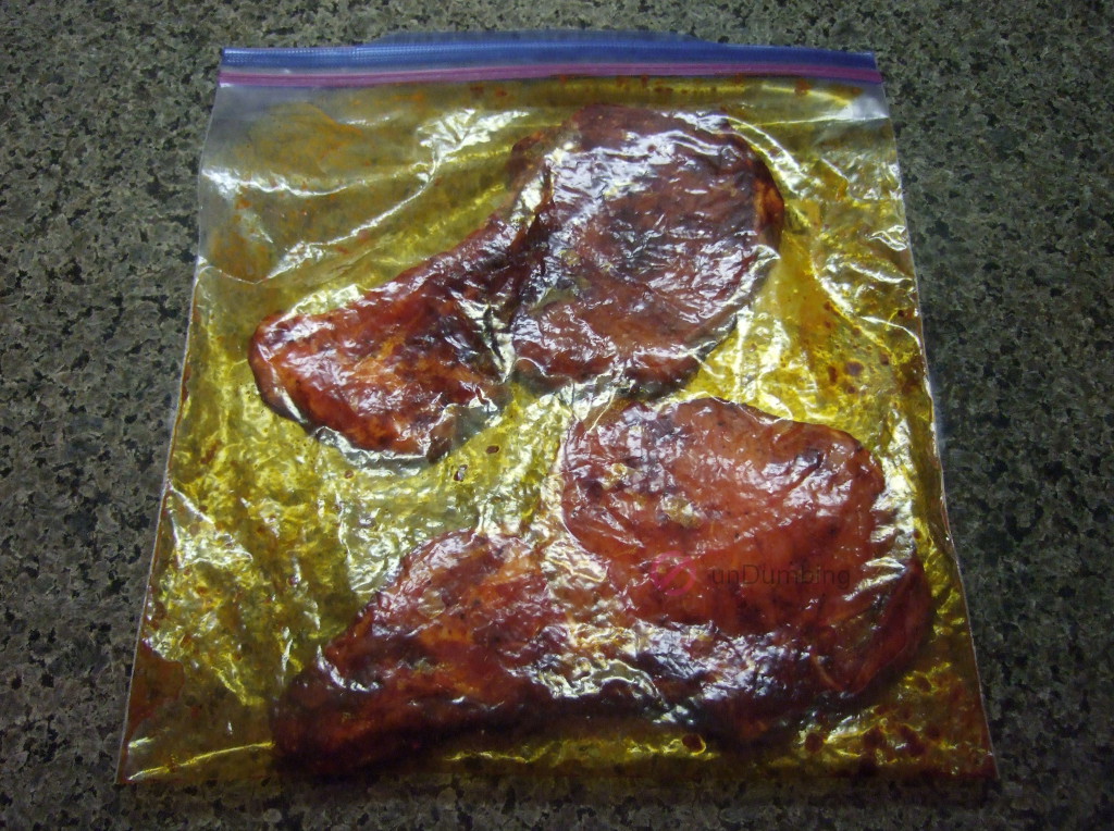 Pork chops rubbed with seasoning in a clear plastic bag (Try 2)