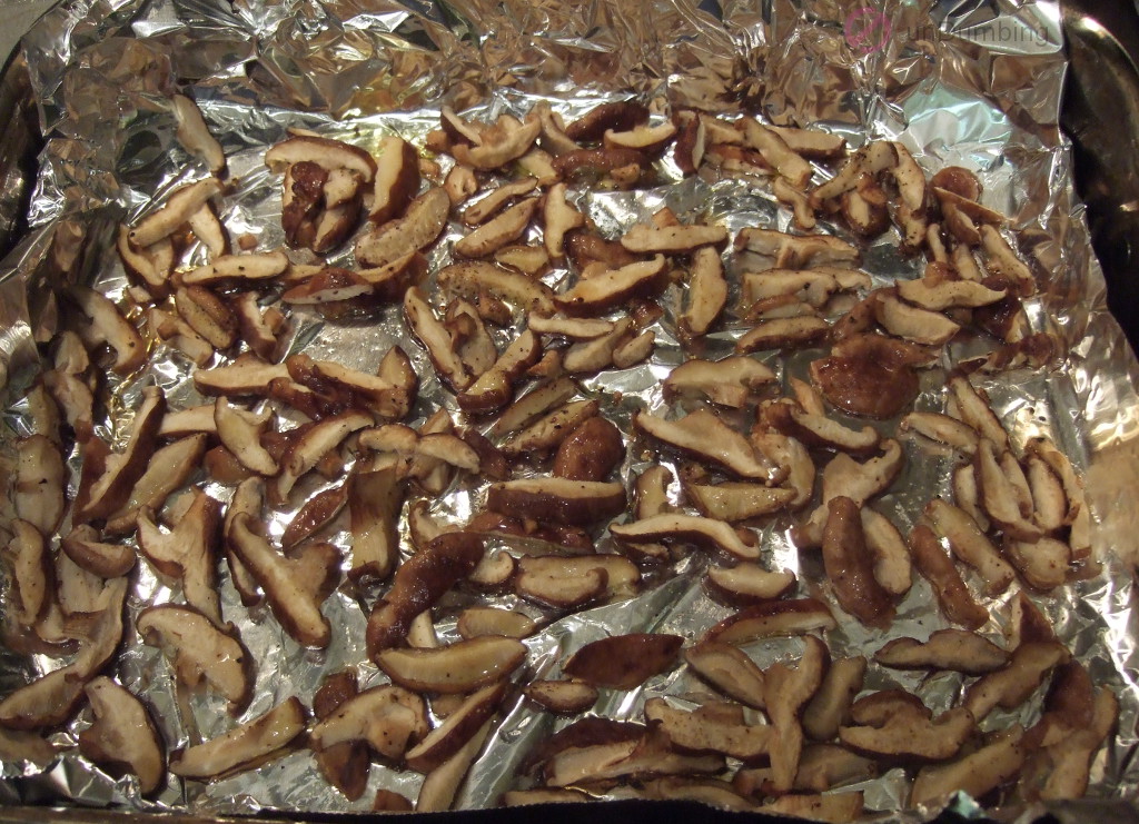 Roasted mushrooms on a foil-lined roasting pan