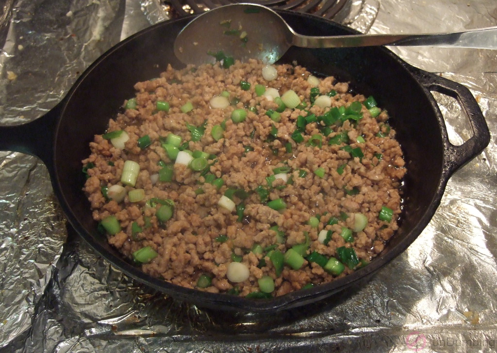 Sesame oil and scallion added to the skillet