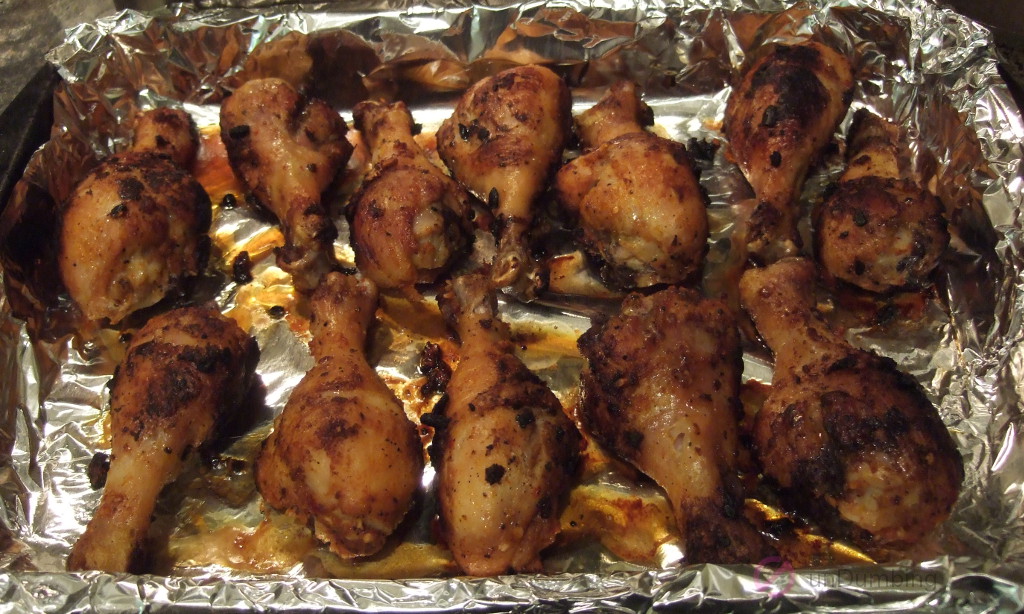 Baked chicken drumsticks from the oven in a foil-lined baking pan