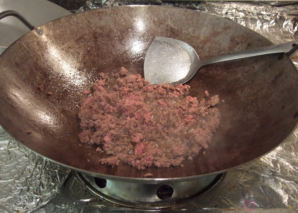 Ground beef almost cooked in the wok