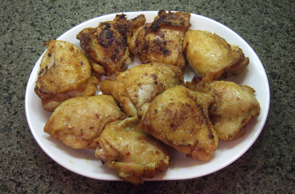 Baked chicken thighs on a white plate