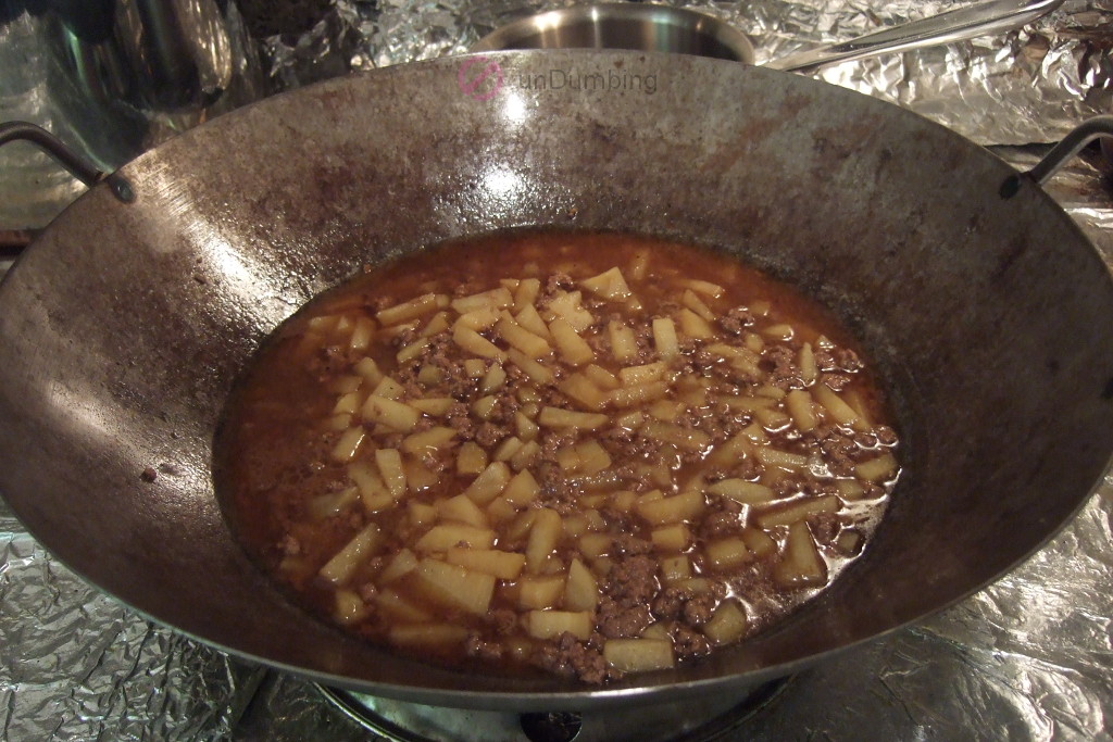 Cooked ground beef and potatoes in the wok